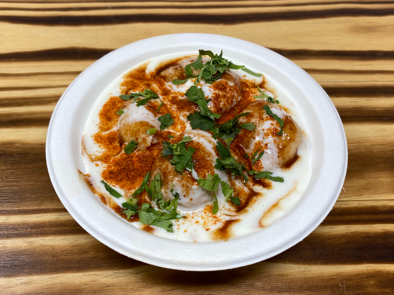Soft lentil fritters soaked in creamy yogurt and sweet chutney topped with our masala mix 